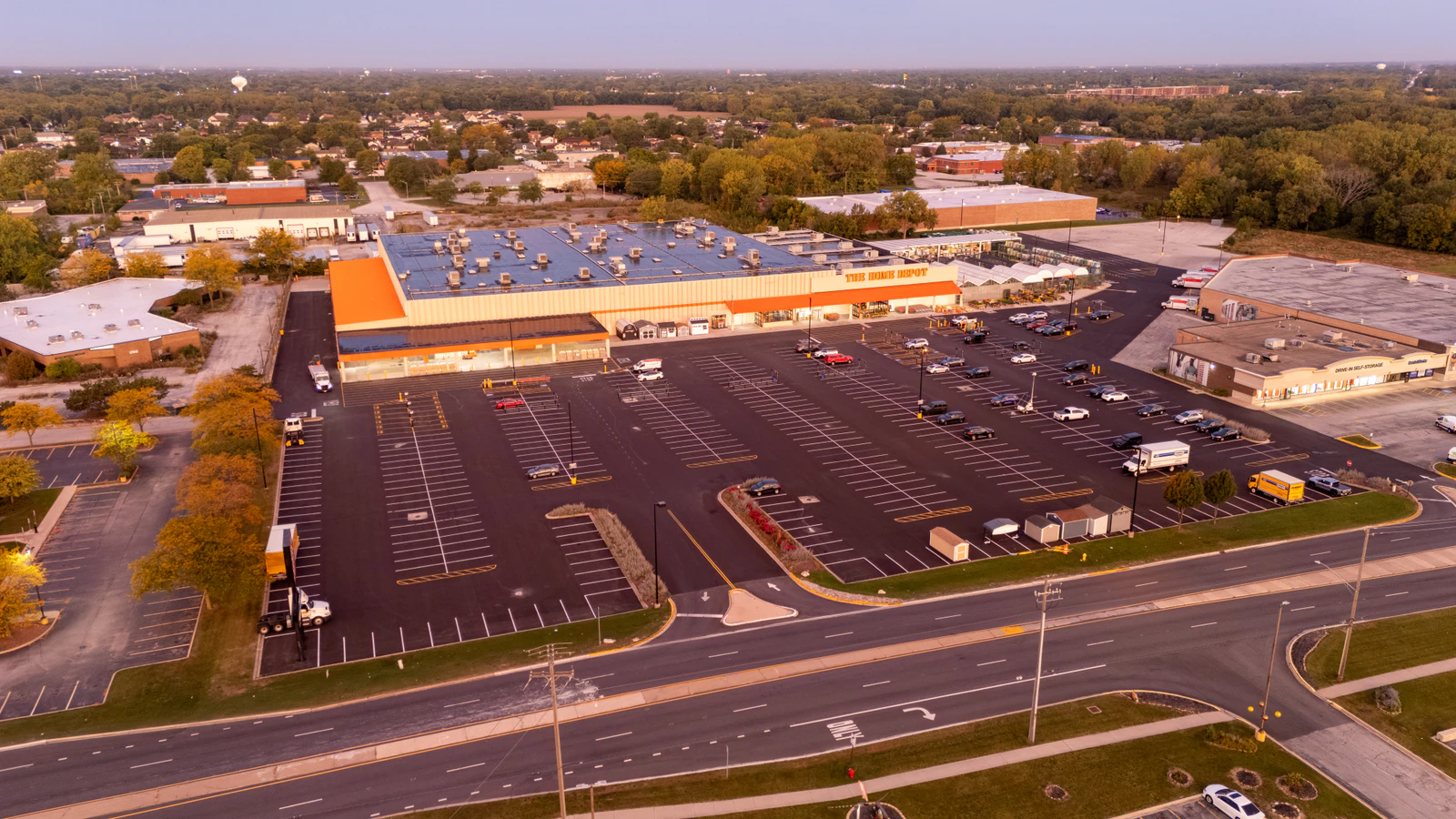 Sunrise aerial view of a Home Depot parking lot freshly paved and striped by Advantage Paving