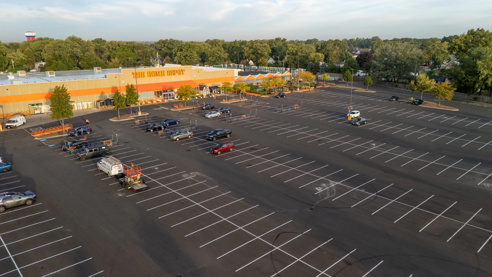 Early-morning aerial view of a freshly paved and striped Home Depot parking lot completed by Advantage Paving
